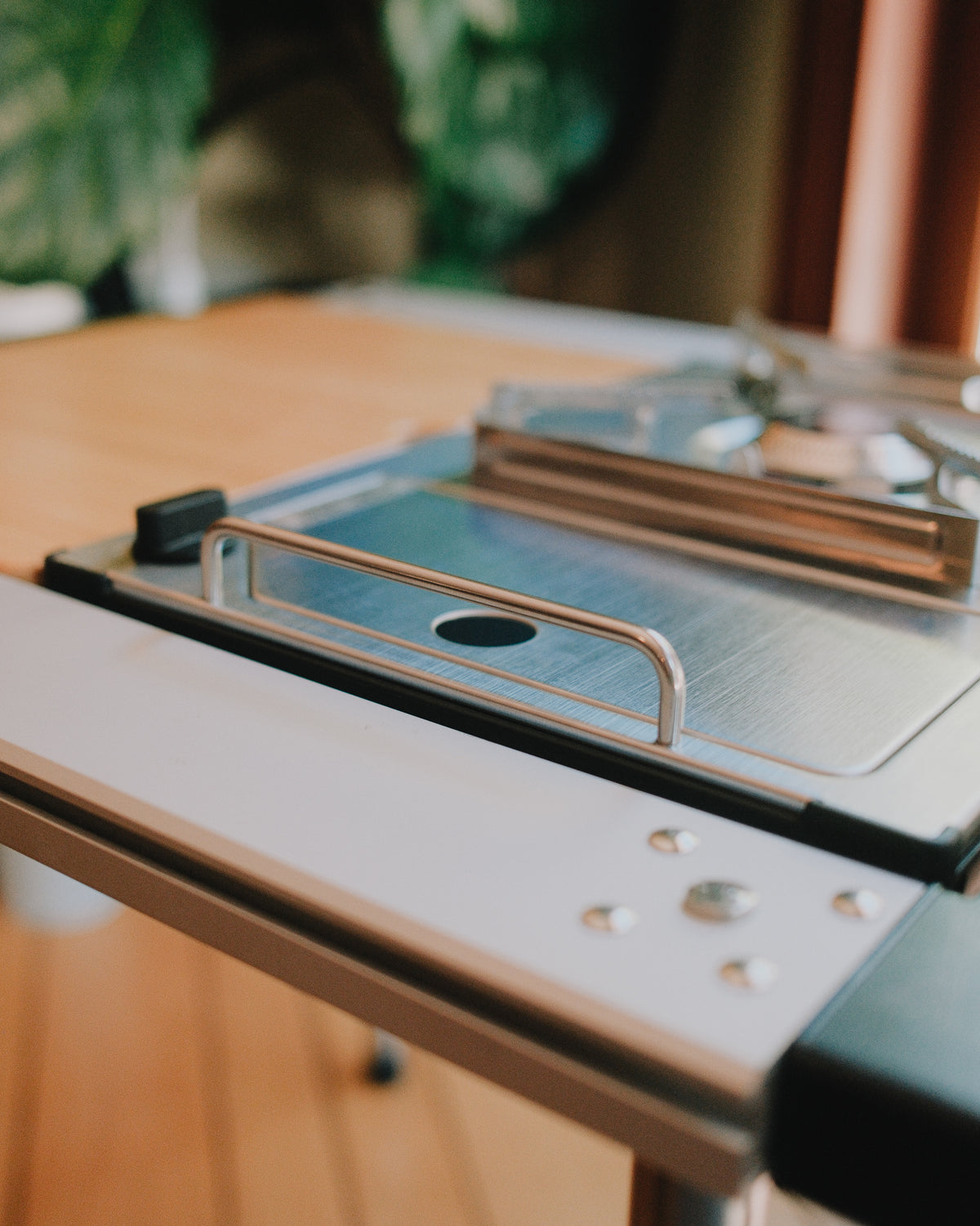 Kovea table stove fitted in an aluminum IGT frame, showing the windscreen and frame edge