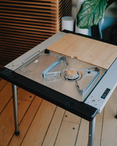 Kovea Portable IGT Table Stove installed in an IGT frame with legs and a bamboo table insert