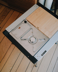 Kovea Portable IGT Table Stove set flush in a Stanluck IGT frame beside a bamboo table, top view